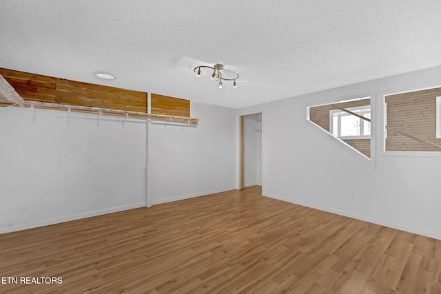 interior space featuring hardwood / wood-style flooring and a textured ceiling