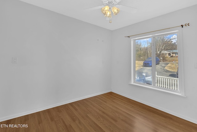 empty room with hardwood / wood-style flooring and ceiling fan