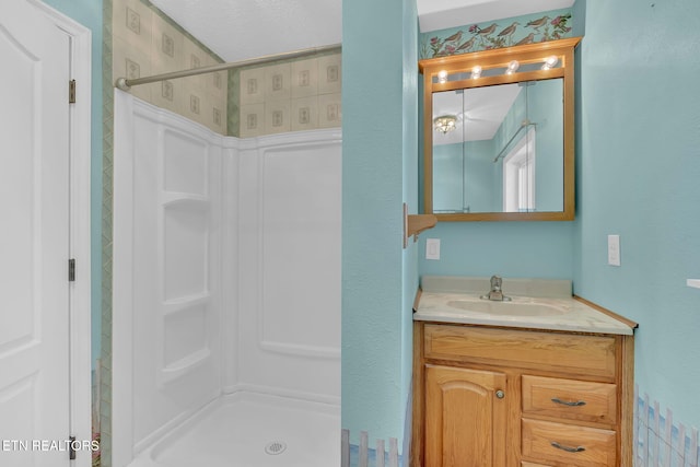 bathroom with a shower and vanity