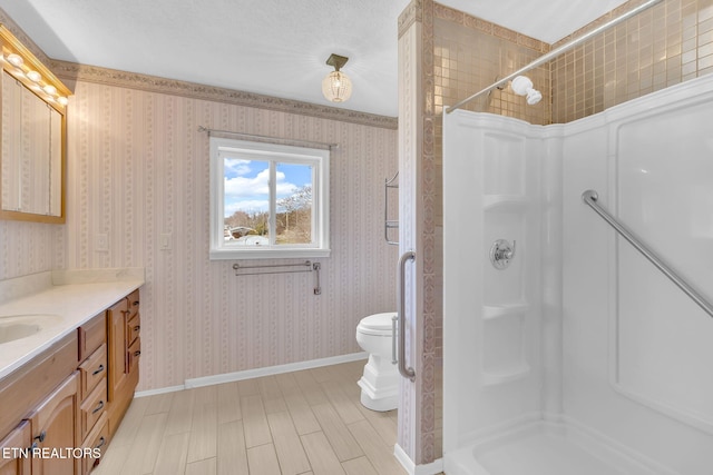 bathroom with hardwood / wood-style flooring, vanity, toilet, and walk in shower