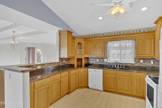 kitchen with vaulted ceiling, sink, kitchen peninsula, white appliances, and light hardwood / wood-style flooring