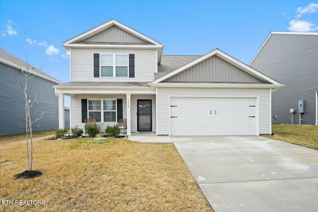 view of front of property featuring a garage and a front lawn