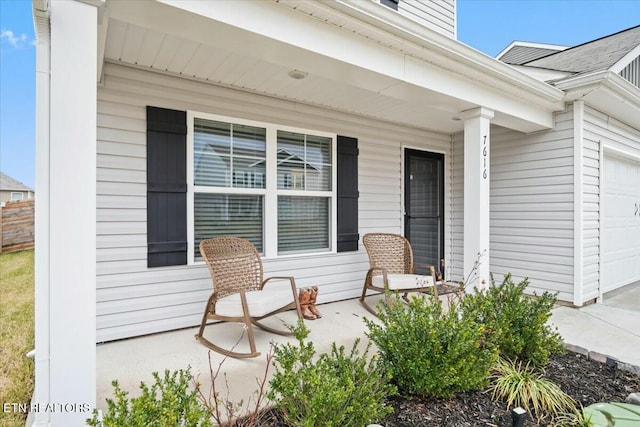 doorway to property featuring a garage and covered porch