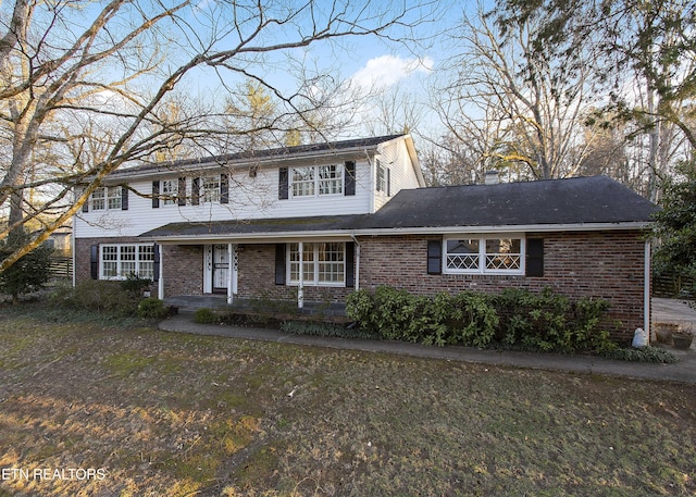 view of property featuring a front lawn