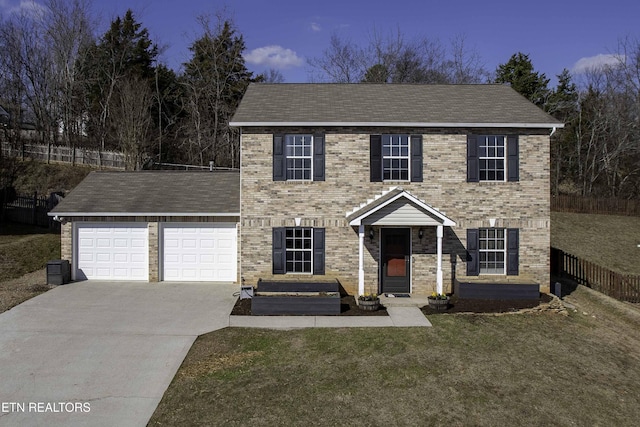 colonial home featuring a garage and a lawn