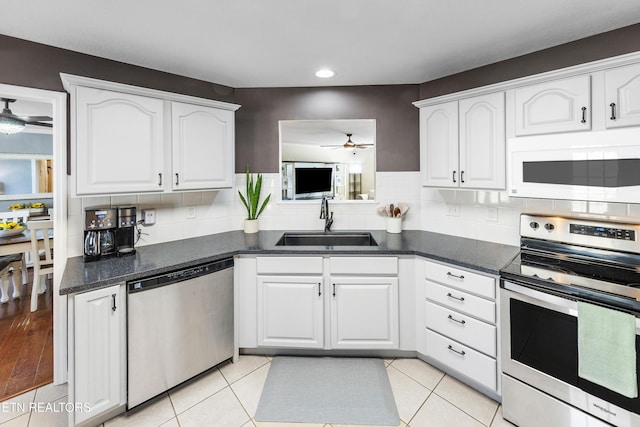 kitchen featuring white cabinetry, ceiling fan, appliances with stainless steel finishes, and sink