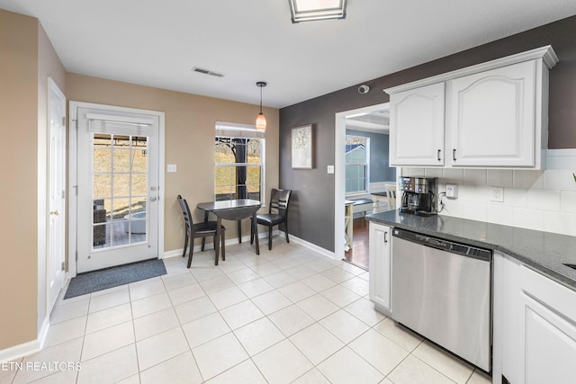 kitchen featuring light tile patterned floors, white cabinetry, tasteful backsplash, decorative light fixtures, and stainless steel dishwasher