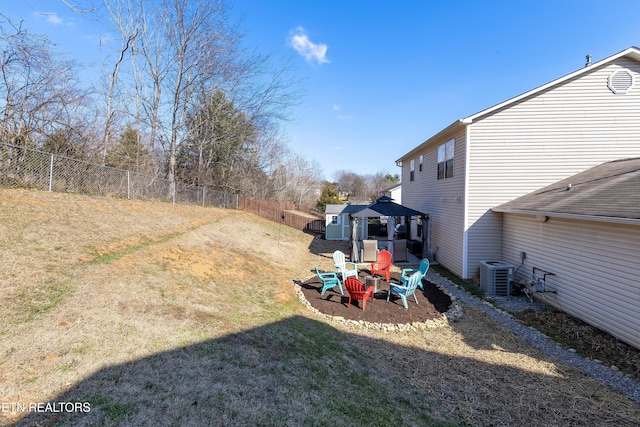 view of yard with a gazebo, an outdoor fire pit, and central AC