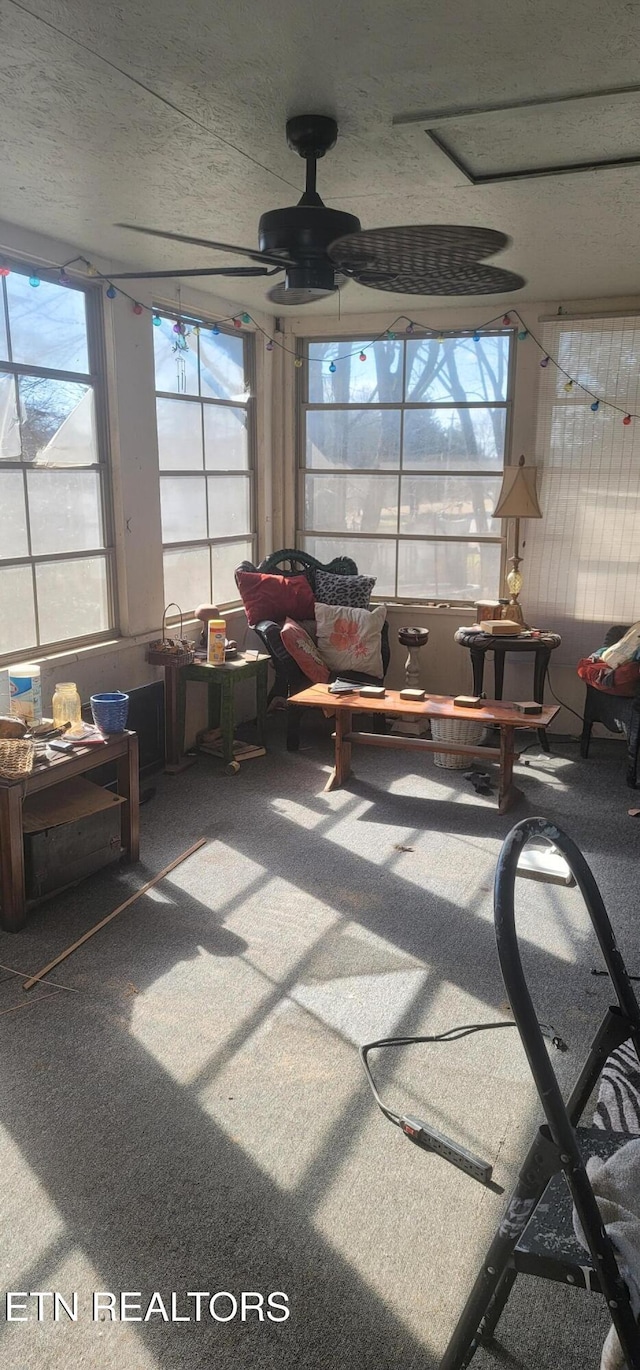 sunroom / solarium featuring ceiling fan