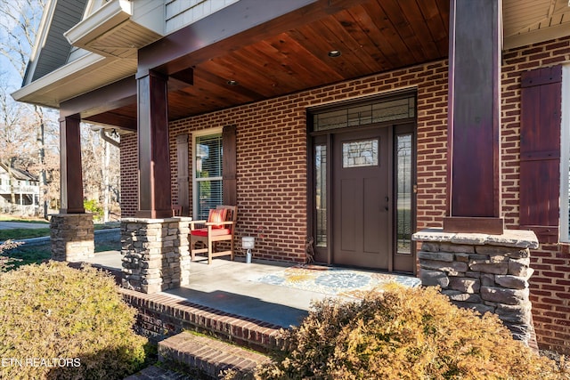 view of exterior entry with a porch