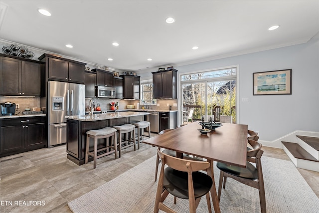 dining area featuring ornamental molding and sink