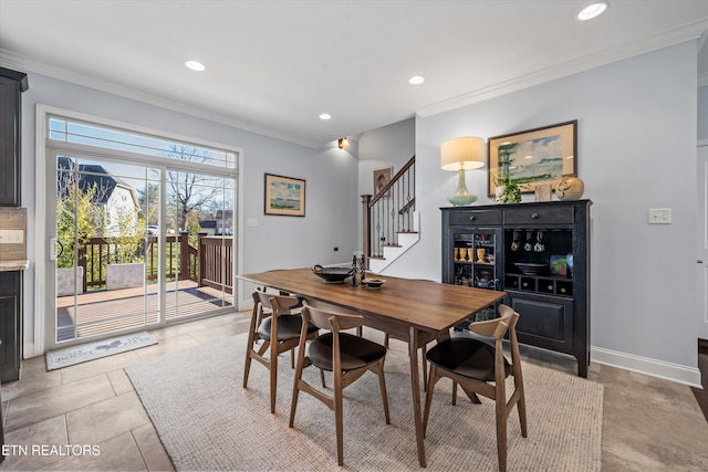 dining space with light tile patterned floors and crown molding