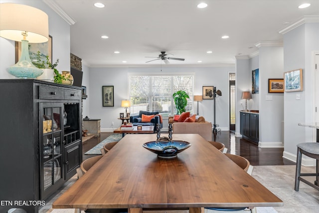 dining room featuring crown molding, dark wood-type flooring, and ceiling fan