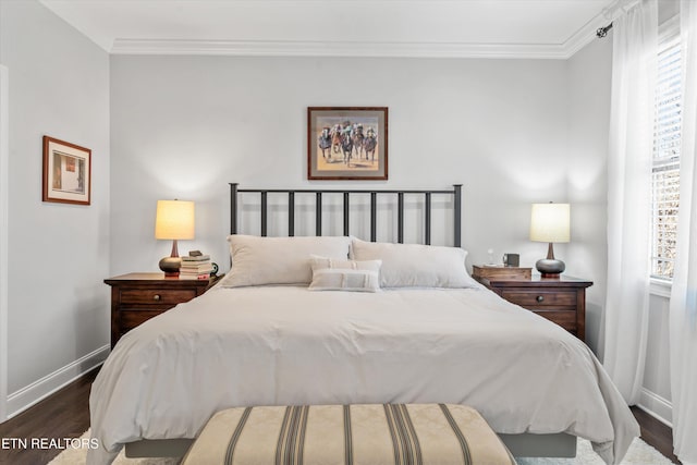 bedroom with crown molding and dark hardwood / wood-style flooring