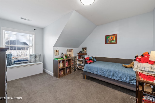 bedroom featuring vaulted ceiling and carpet