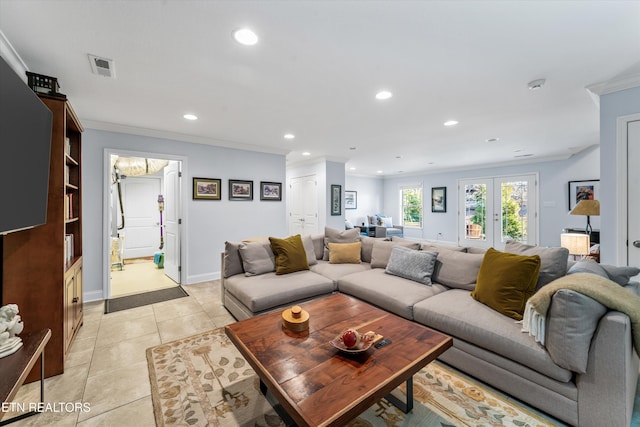 tiled living room featuring ornamental molding and french doors