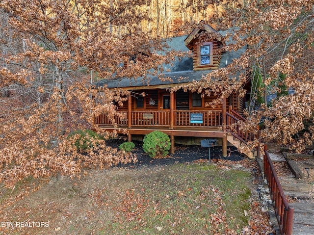 rear view of property featuring a porch