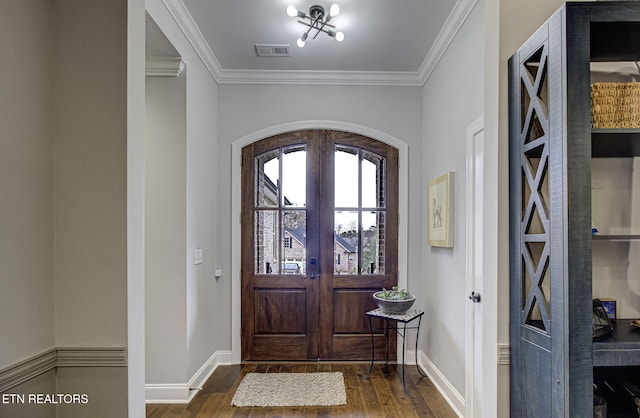 foyer entrance featuring crown molding, dark hardwood / wood-style floors, and french doors