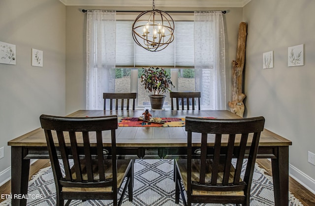 dining room with hardwood / wood-style flooring and an inviting chandelier