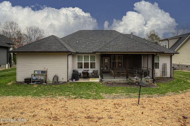 back of property featuring a yard and a patio