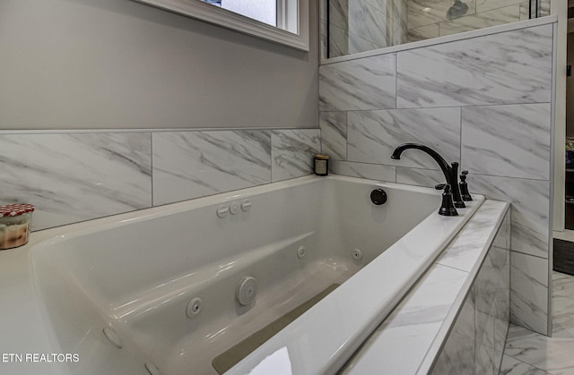 bathroom featuring tiled tub