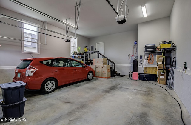 garage with a garage door opener and water heater