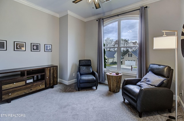 living area with crown molding, ceiling fan, and carpet flooring