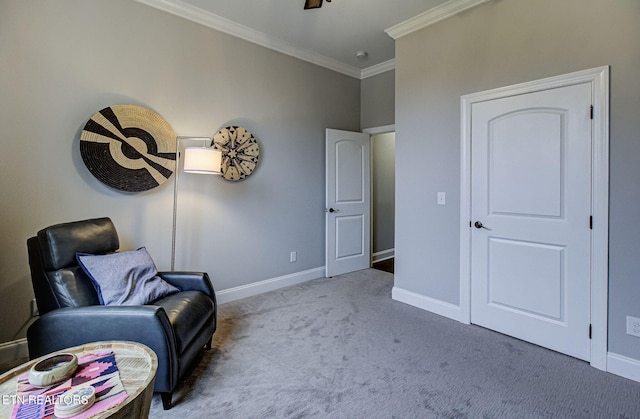 living area with crown molding and carpet