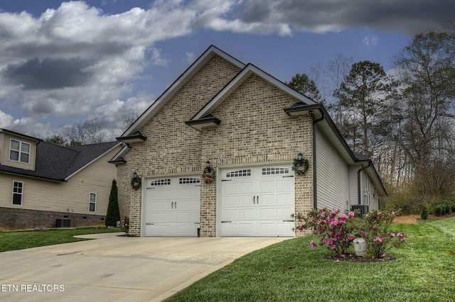 view of side of home featuring central AC, a garage, and a yard