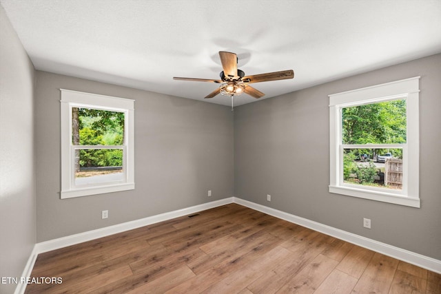 empty room with wood-type flooring and ceiling fan