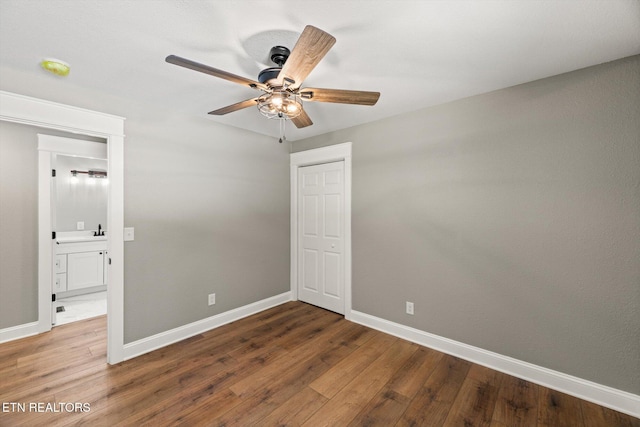 unfurnished bedroom with hardwood / wood-style flooring, a closet, and ceiling fan