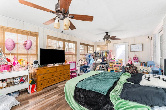 bedroom with wood finished floors and a ceiling fan