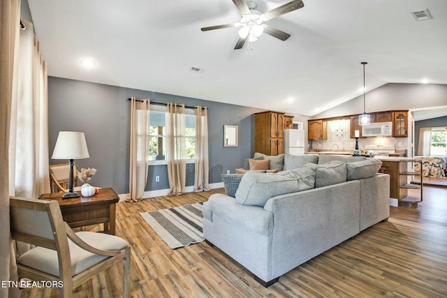 living room with vaulted ceiling, sink, ceiling fan, and light hardwood / wood-style floors