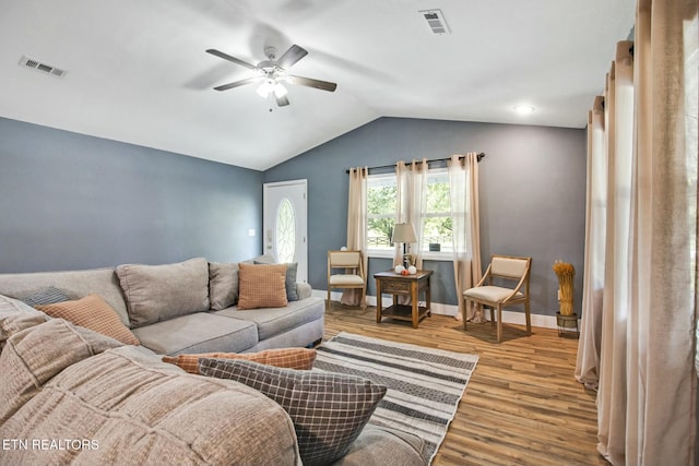 living room with ceiling fan, lofted ceiling, and light hardwood / wood-style flooring