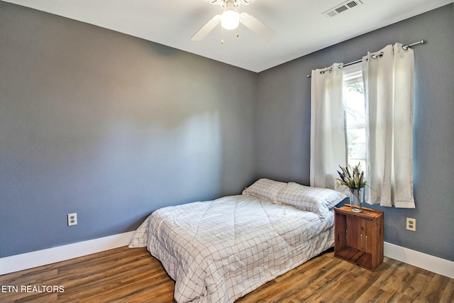 bedroom featuring ceiling fan and dark hardwood / wood-style flooring