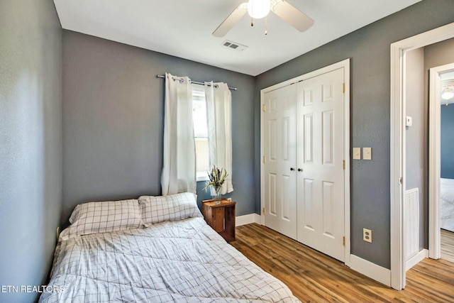 bedroom featuring wood-type flooring, a closet, and ceiling fan