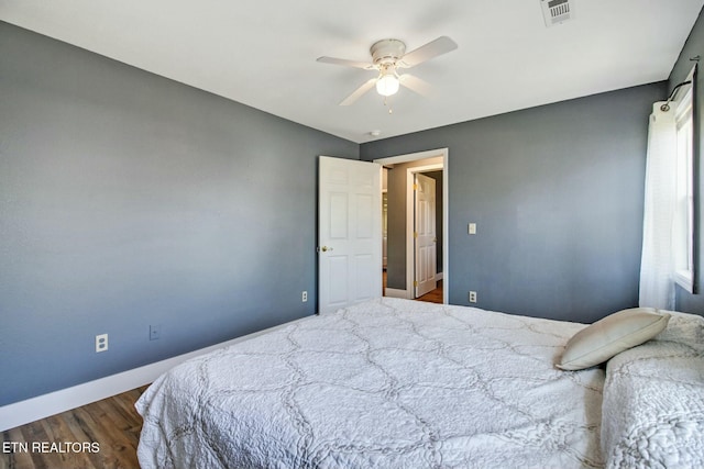 bedroom with ceiling fan and dark hardwood / wood-style flooring