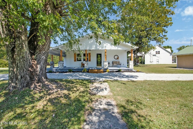 view of front of house with covered porch and a front yard