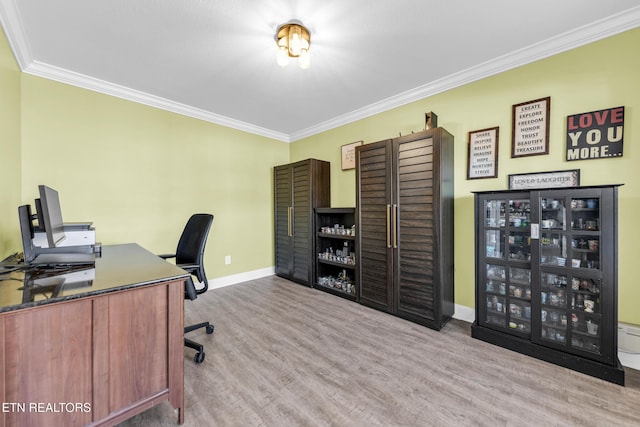 home office with crown molding and light hardwood / wood-style flooring