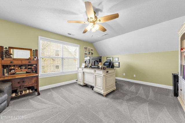 carpeted office space featuring ceiling fan and vaulted ceiling