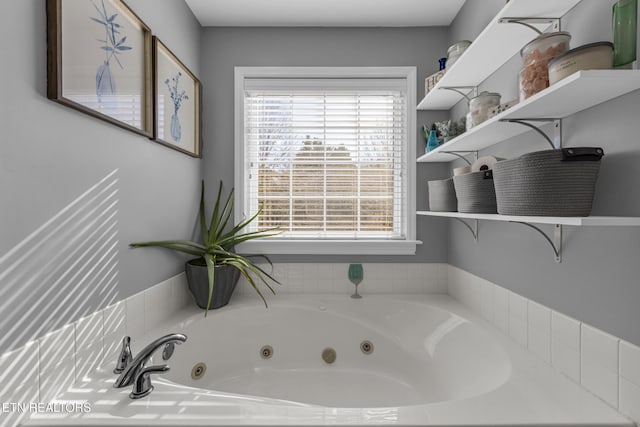 bathroom featuring a relaxing tiled tub