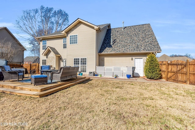 back of house with outdoor lounge area, a deck, and a lawn