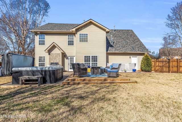 back of property featuring a hot tub, a wooden deck, an outdoor hangout area, and a yard