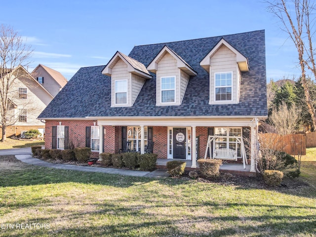 view of front of property featuring covered porch and a front lawn