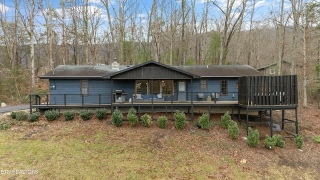 view of front of home featuring a front yard and a deck