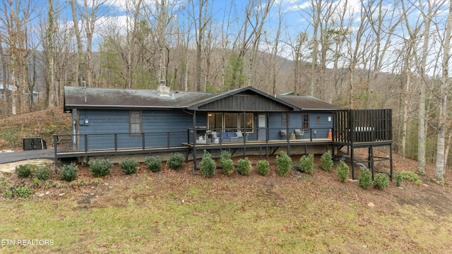 view of front of house featuring a front yard and a deck