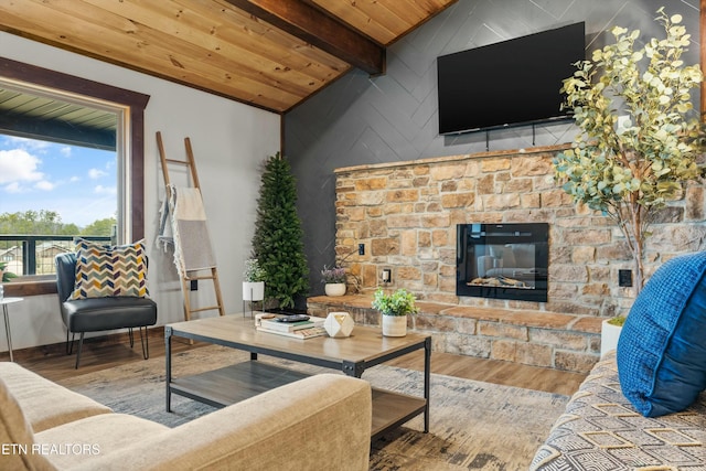 living room featuring a stone fireplace, wood-type flooring, wooden ceiling, and beamed ceiling