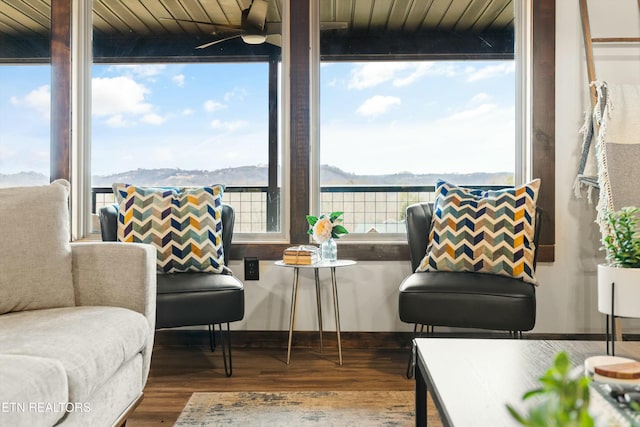 living area featuring ceiling fan, a mountain view, and hardwood / wood-style floors