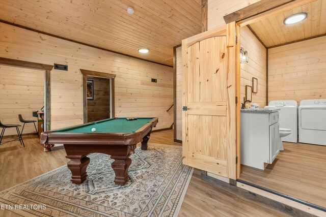 rec room with wooden ceiling, washing machine and clothes dryer, wooden walls, and light hardwood / wood-style flooring