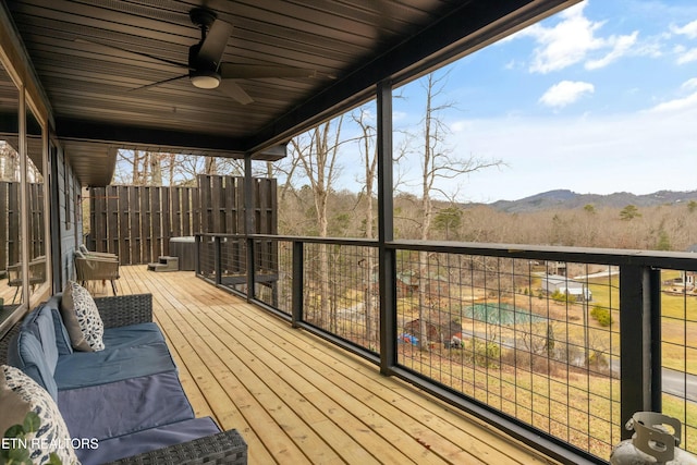 wooden terrace with ceiling fan and a mountain view